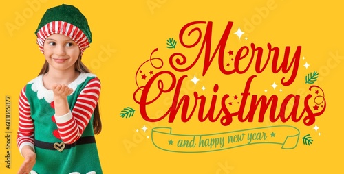 Cute little girl in elf's costume blowing on yellow background. Merry Christmas and Happy New Year