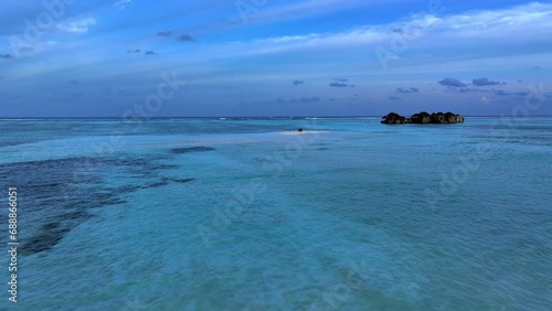 Aerial Forward Beautiful Shot Of Tranquil Sea Under Cloudy Sky - Hithadhoo, Maldives photo