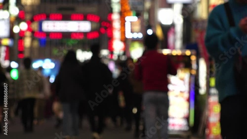 SHINJUKU, TOKYO, JAPAN - NOV 2023 : KABUKICHO downtown area at night. Colorful led neon street signs at entertainment district. Japanese urban city nightlife, bar, club and drinking concept video. photo