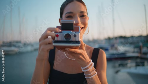 Woman taking picture embankment at vacation closeup. Girl looking in camera lens photo