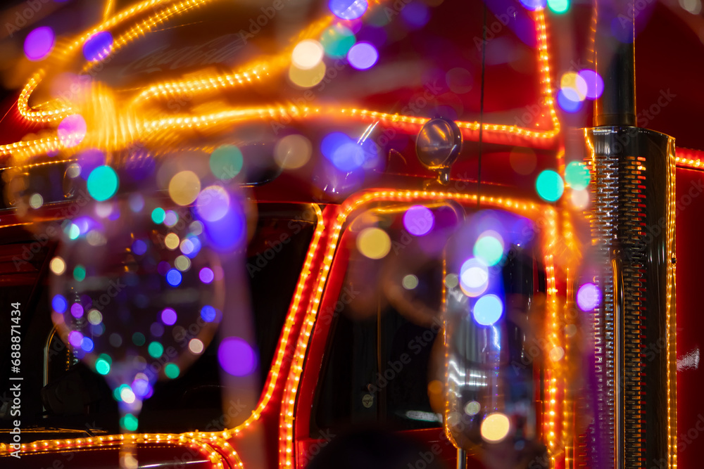 Red Santa Claus truck, colorful lights, close-up, selective focus. Concept: Christmas and New Year's Eve, public holiday.
