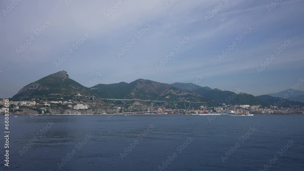 Cinematic view from tourist ferry on Salerno coastline and hills. Sailing on the Mediterranean sea near Amalfi coast in Campania. Looking at hillside town houses on Amalfi coast from ferry boat Cinematic view from tourist ferry on Salerno coastline and hills. Sailing on the Mediterranean sea near Amalfi coast in Campania. Looking at hillside town houses on Amalfi coast from ferry boat
