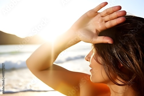 ビーチで日差しを浴びる女性
