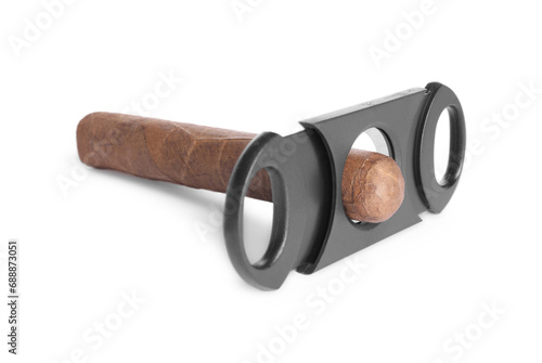 Cigar wrapped in tobacco leaf and cutter isolated on white photo