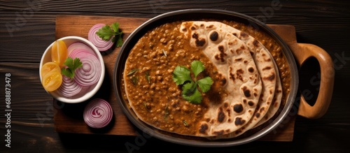 Valentine's day breakfast: Heart-shaped Indian flat bread served with dal makhani in a tray, seen from above. photo