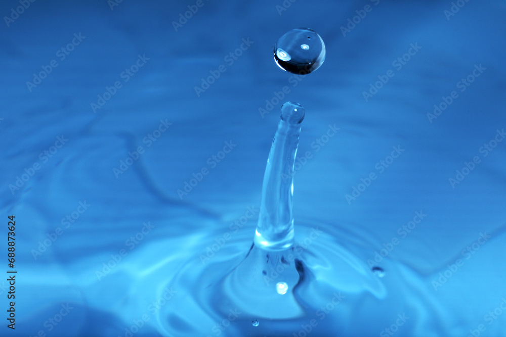 Splash of blue water with drop, macro view Splash of blue water with drop, macro view