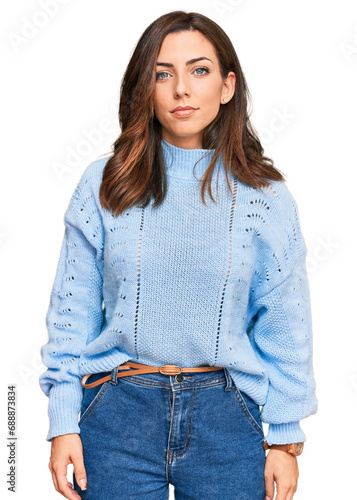 Fotografía Young brunette woman wearing casual winter sweater relaxed with serious expression on face
