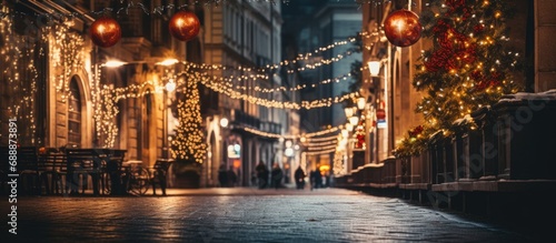 Fototapeta Naklejka Na Ścianę i Meble -  Street with fairy lights, buildings with a view.