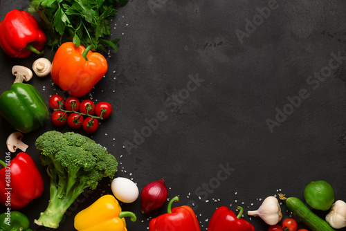 Fresh vegetables, fruits and mushrooms on black background