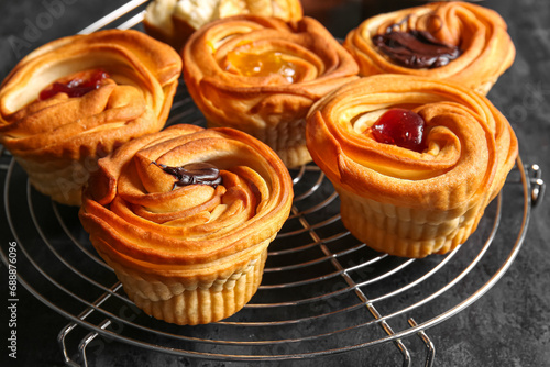 Grid of tasty cruffins with chocolate and jam on black background photo