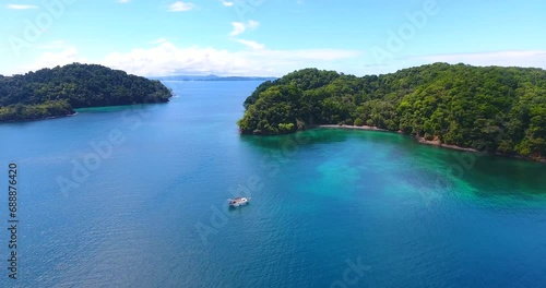 Flying in on a monohull sailboat anchored in a pristine bay next to Afuera Island in Panama photo