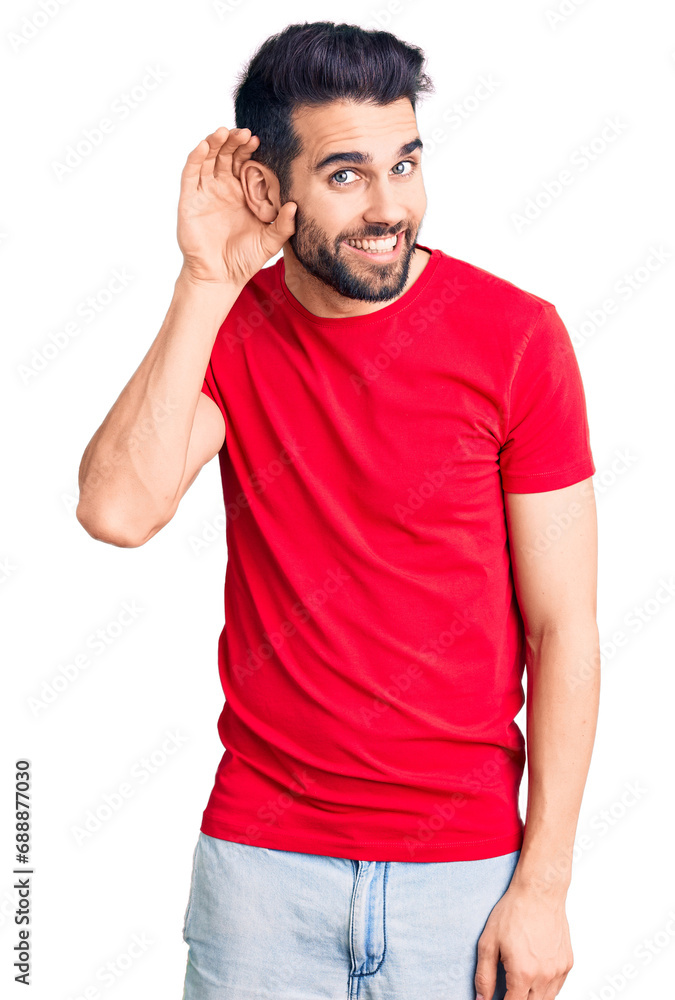 Young handsome man with beard wearing casual t-shirt smiling with hand over ear listening an hearing to rumor or gossip. deafness concept. Young handsome man with beard wearing casual t-shirt smiling with hand over ear listening an hearing to rumor or gossip. deafness concept.
