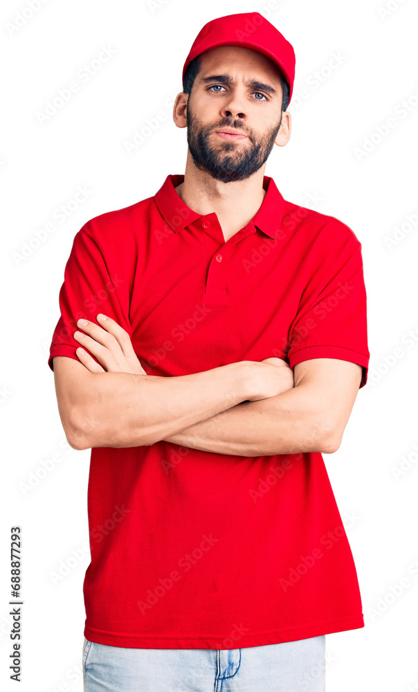 Young handsome man with beard wearing delivery uniform skeptic and nervous, disapproving expression on face with crossed arms. negative person. Young handsome man with beard wearing delivery uniform skeptic and nervous, disapproving expression on face with crossed arms. negative person.