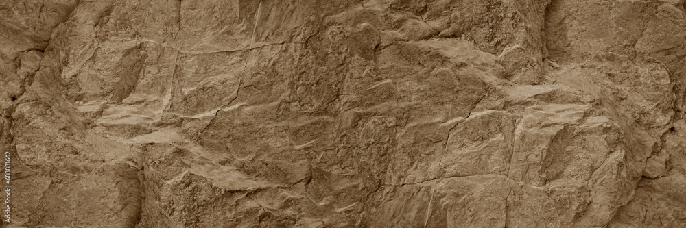 Light pale brown dark beige stone texture background. Rough rock mountain surface. Nature. Close-up. Vein cracks. Empty space. Design. Wide banner. Panoramic.