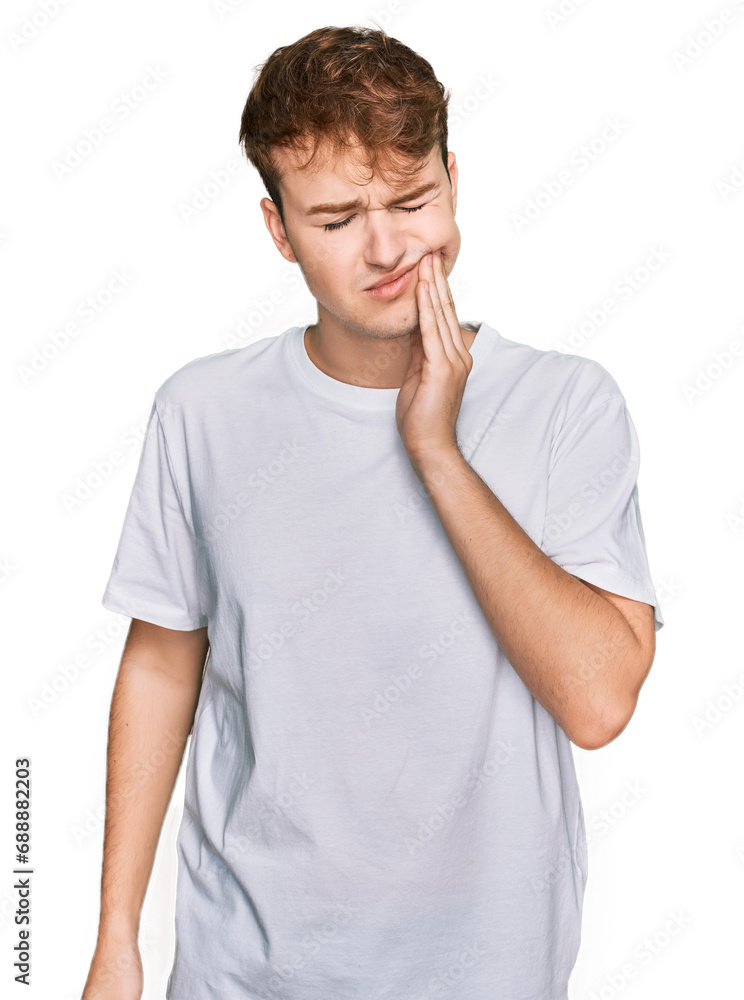Φωτογραφία Young caucasian man wearing casual white t shirt touching mouth with hand with painful expression because of toothache or dental illness on teeth