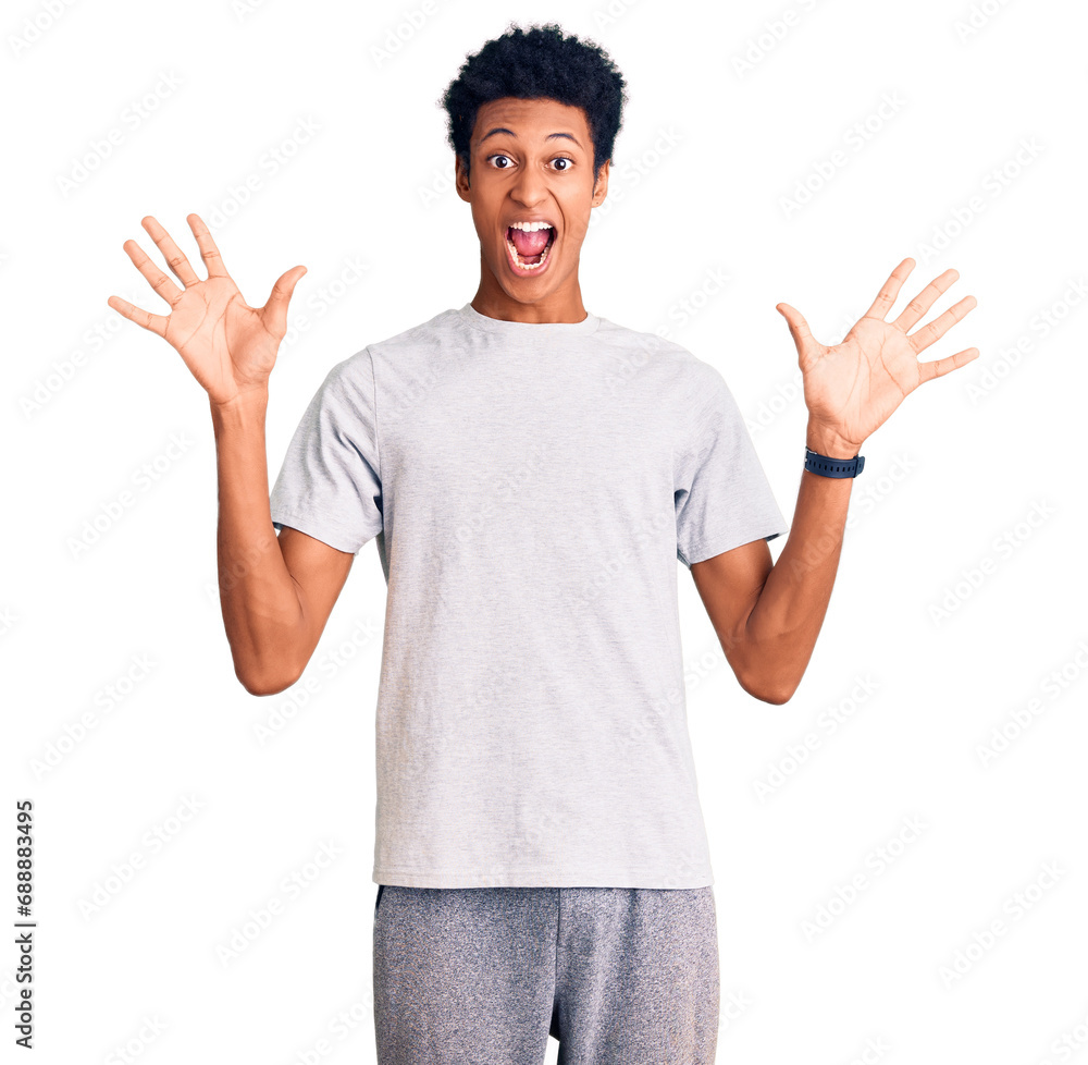 Young african american man wearing casual clothes celebrating crazy and amazed for success with arms raised and open eyes screaming excited. winner concept Young african american man wearing casual clothes celebrating crazy and amazed for success with arms raised and open eyes screaming excited. winner concept