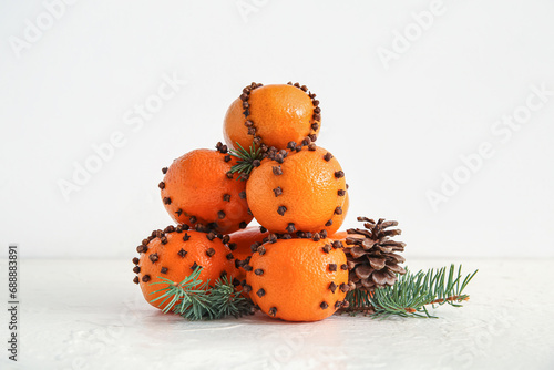 Pomander balls with Christmas tree branches and cone on white background