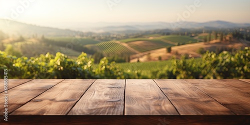 Wooden table overlooking a lush vineyard at sunset, suitable for winery and travel marketing. photo