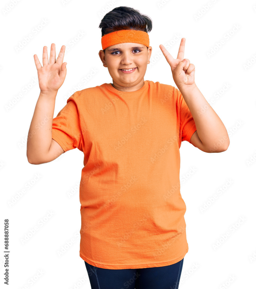 Little boy kid wearing sportswear showing and pointing up with fingers number seven while smiling confident and happy. Little boy kid wearing sportswear showing and pointing up with fingers number seven while smiling confident and happy.