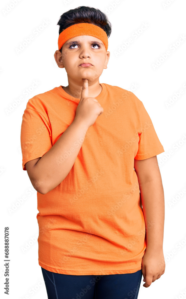 Little boy kid wearing sportswear thinking concentrated about doubt with finger on chin and looking up wondering Little boy kid wearing sportswear thinking concentrated about doubt with finger on chin and looking up wondering