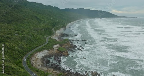 Wallpaper Mural Aerial flight following a tourist campervan driving on a wild, rugged and remote coastal road on the West Coast, South Island of New Zealand Aotearoa Torontodigital.ca