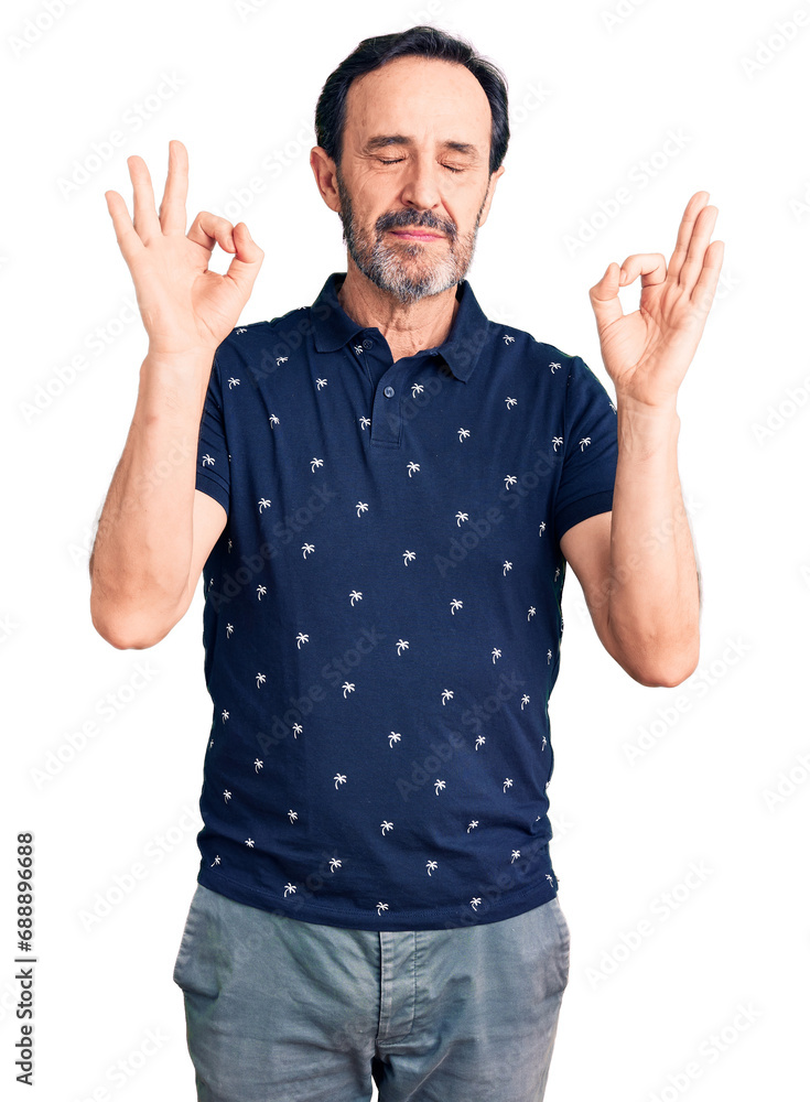 Middle age handsome man wearing casual polo relax and smiling with eyes closed doing meditation gesture with fingers. yoga concept. Middle age handsome man wearing casual polo relax and smiling with eyes closed doing meditation gesture with fingers. yoga concept.