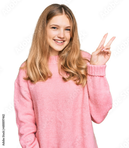 Wallpaper Mural Beautiful young caucasian girl wearing casual winter sweater smiling with happy face winking at the camera doing victory sign. number two. Torontodigital.ca