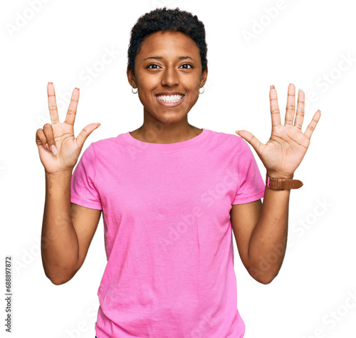 Young african american woman wearing casual clothes showing and pointing up with fingers number eight while smiling confident and happy.