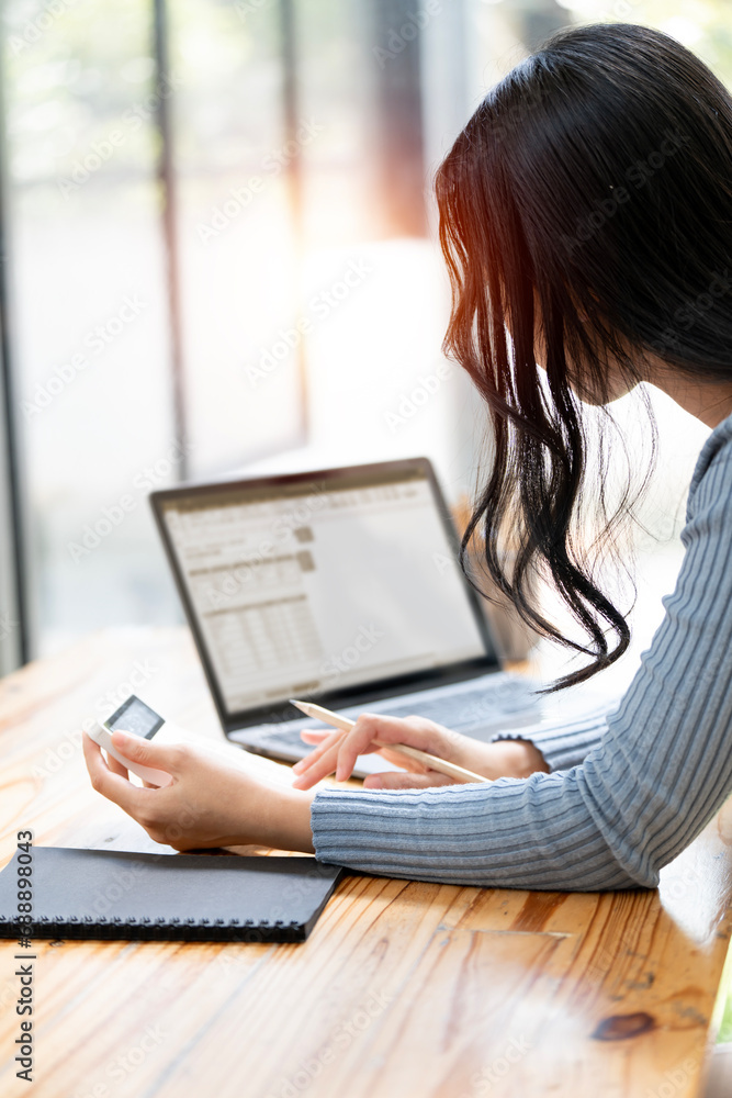 Fototapeta premium Businesswoman working at office with document on her desk, doing planning analyzing the financial report, business plan investment, finance analysis concept.Using calculator machine.