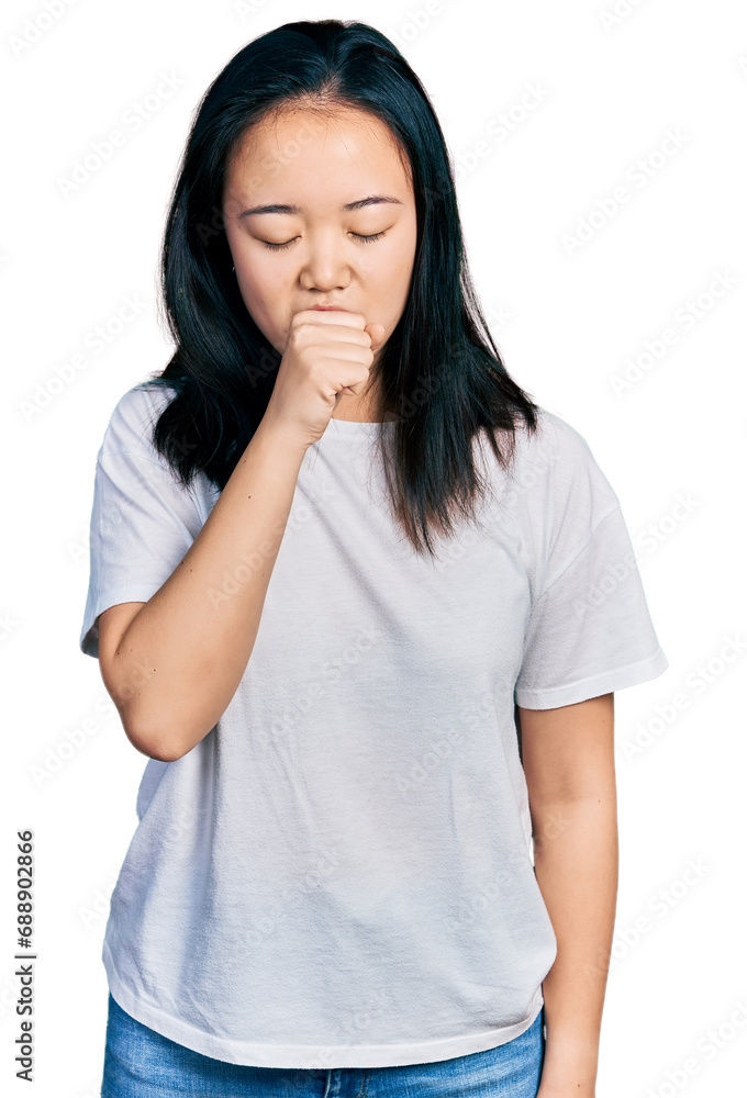 Young chinese woman wearing casual white t shirt feeling unwell and coughing as symptom for cold or bronchitis. health care concept. Young chinese woman wearing casual white t shirt feeling unwell and coughing as symptom for cold or bronchitis. health care concept.