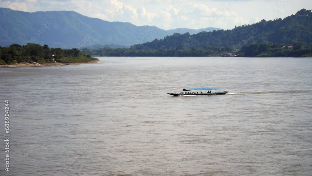 slow boat cruising along the Mekong River, Local boat moving on Mekong river between the border of Thailand and Laos, Boat transport on the river, transport ship slow boat cruising along the Mekong River, Local boat moving on Mekong river between the border of Thailand and Laos, Boat transport on the river, transport ship