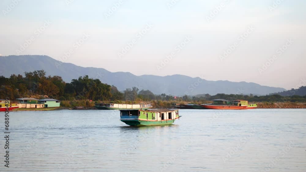 slow boat cruising along the Mekong River, Local boat moving on Mekong river between the border of Thailand and Laos, Boat transport on the river, transport ship slow boat cruising along the Mekong River, Local boat moving on Mekong river between the border of Thailand and Laos, Boat transport on the river, transport ship