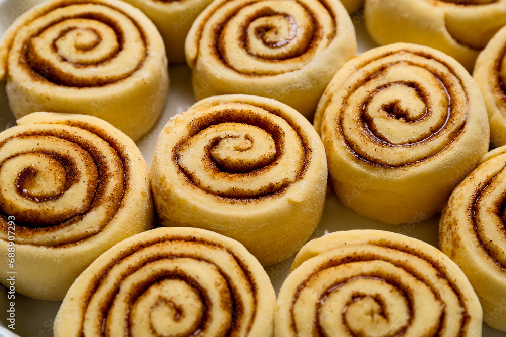 Uncooked cinnamon rolls on baking dish, closeup Uncooked cinnamon rolls on baking dish, closeup