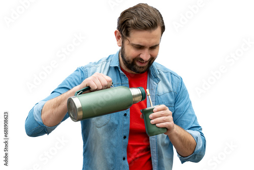 Young man serving mate leaving it ready to drink.