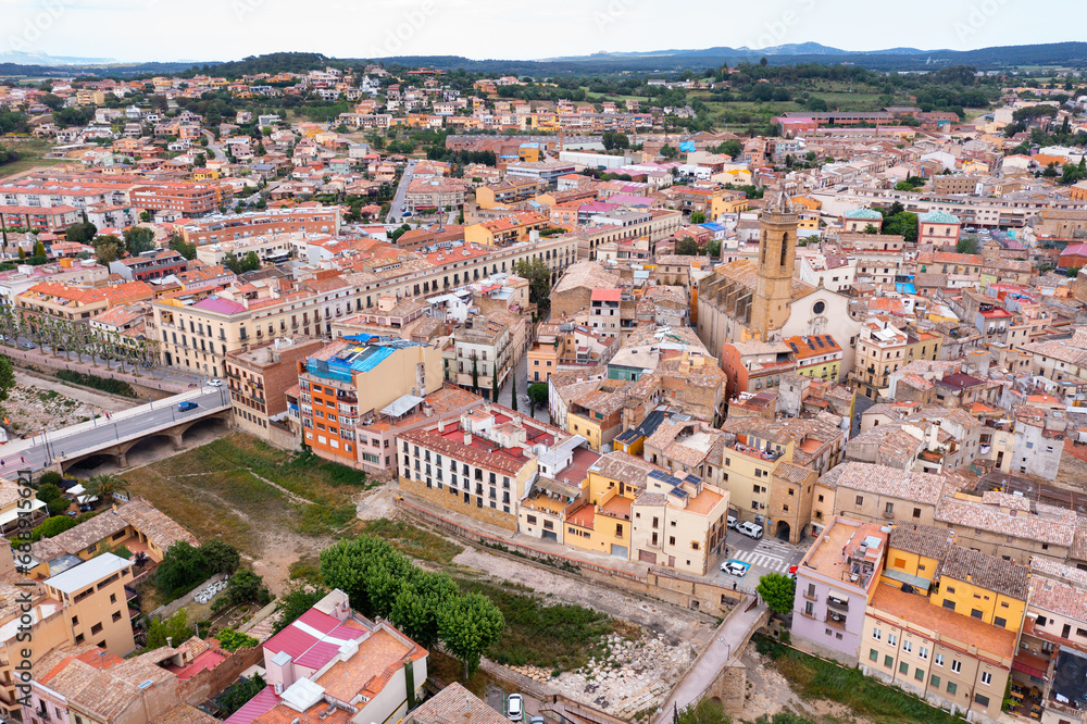 Summer view from drone of center of medieval Spanish town of La Bisbal d Emporda with episcopal palace castle and Church of Santa Maria, province of Girona, Catalonia..
