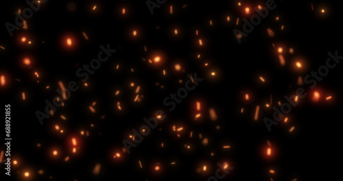 Abstract bright background of flying yellow glowing orange fire sparks from a fire on a black background photo