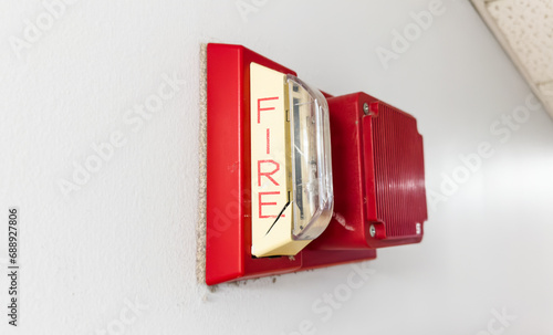 red fire alarm on a white wall, symbolizing safety and emergency preparedness
