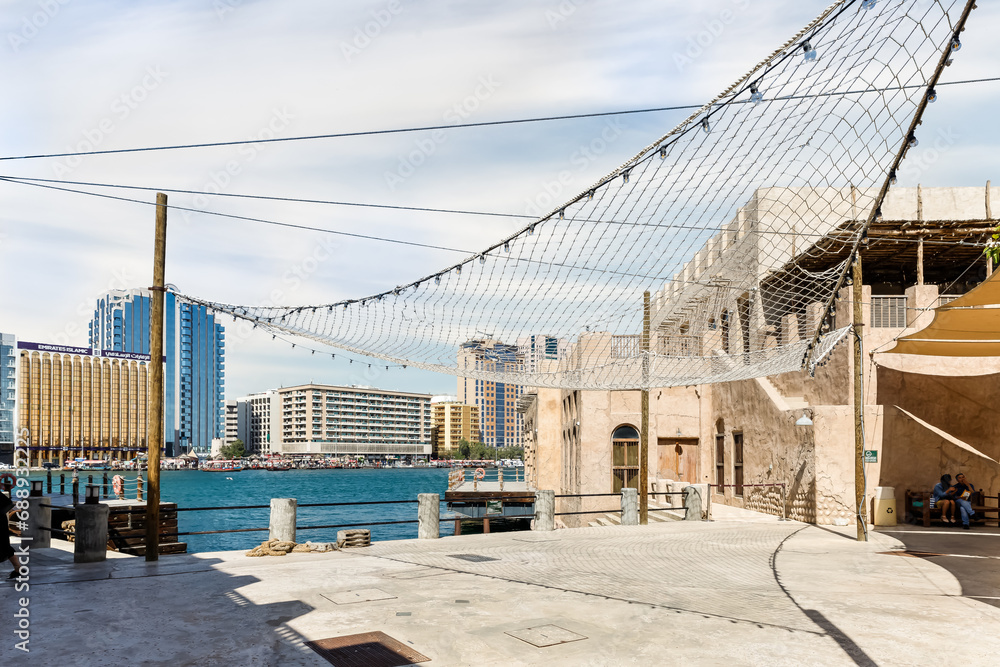 Fototapeta premium The Dubai Creek near the reconstructed old part of the Dubai city - Al-Bastakiya quarter in the Dubai city, United Arab Emirates
