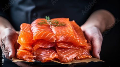 The big salmon is in hands of the experienced Japanese chef. Salmon fillet for sashimi and sushi.