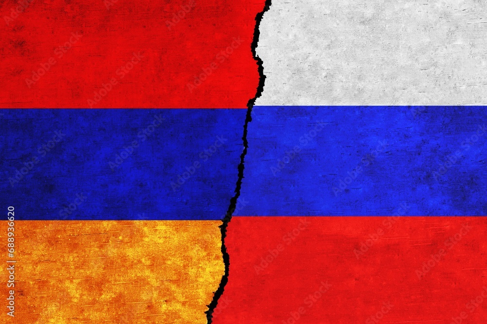 Russia and Armenia painted flags on a wall with a crack. Russia and Armenia relations. Armenia and Russia flags together
