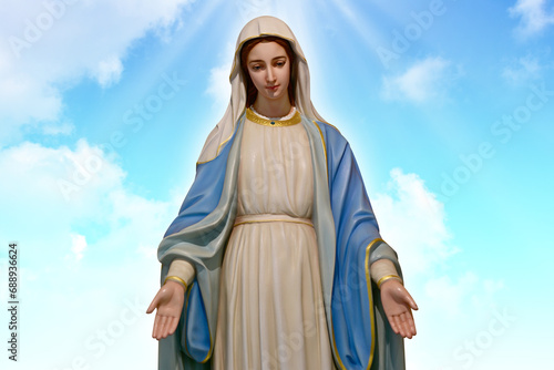 Our lady of grace virgin Mary with Bright Blue Sky and beautiful clouds with abstract colored background and wallpaper.