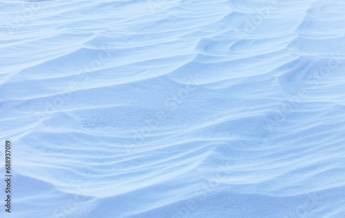 Natural winter texture of snowy crust on beach of frozen Baikal Lake in cold January day. Abstract white and blue snow background in form of frozen waves. Blank, mockup, flat lay, copy space, top view