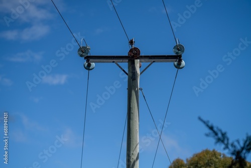 power lines with wooden power poles in tasmania australia.
