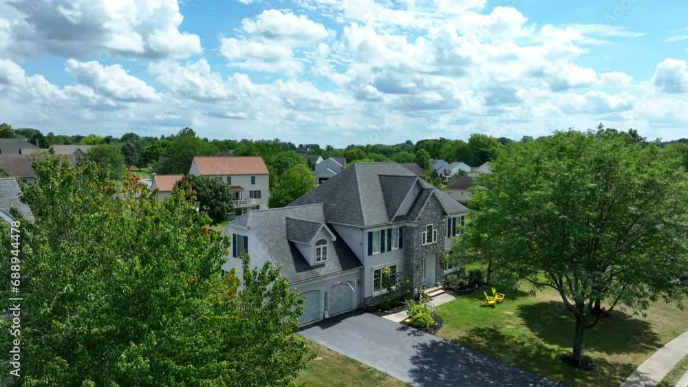 Large house in American neighborhood on summer day. Aerial descending shot. Large house in American neighborhood on summer day. Aerial descending shot.