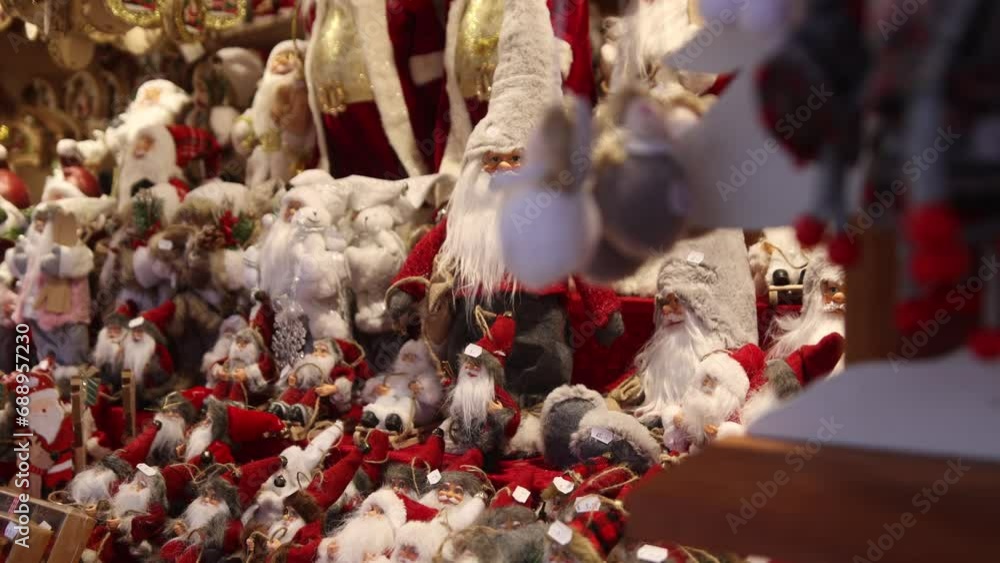 rows of santa clause figurines on a shop display at a Festive Christmas market in Europe rows of santa clause figurines on a shop display at a Festive Christmas market in Europe