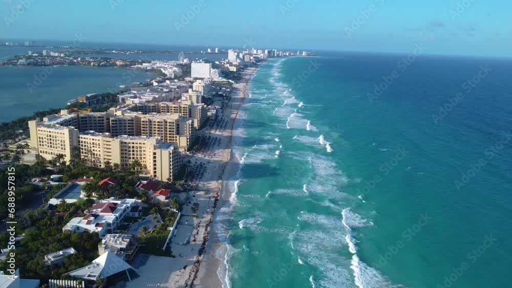 Wide aerial video of the Cancun hotels zone, Caribbean sea, luxury hotel, aerial footage of turquoise blue water and waves crashing Wide aerial video of the Cancun hotels zone, Caribbean sea, luxury hotel, aerial footage of turquoise blue water and waves crashing