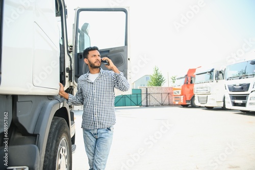 Young Indian truck driver. Concept of road freight transportation.