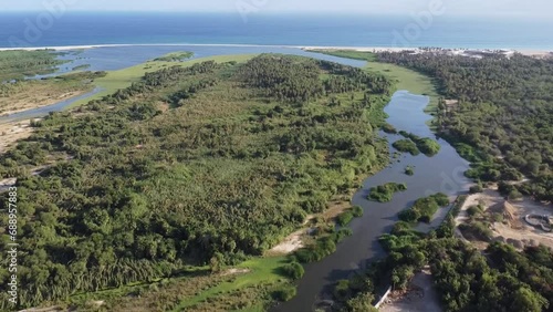 Drone footage of the Reserva Ecologica municipal Estero in San Jose del Cabo Baja California Sur Mexico, wetlands and maritime forest with the ocean in the distance photo