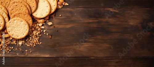 Top view of wooden table with dry crispy crackers on cutting board, providing copy space.