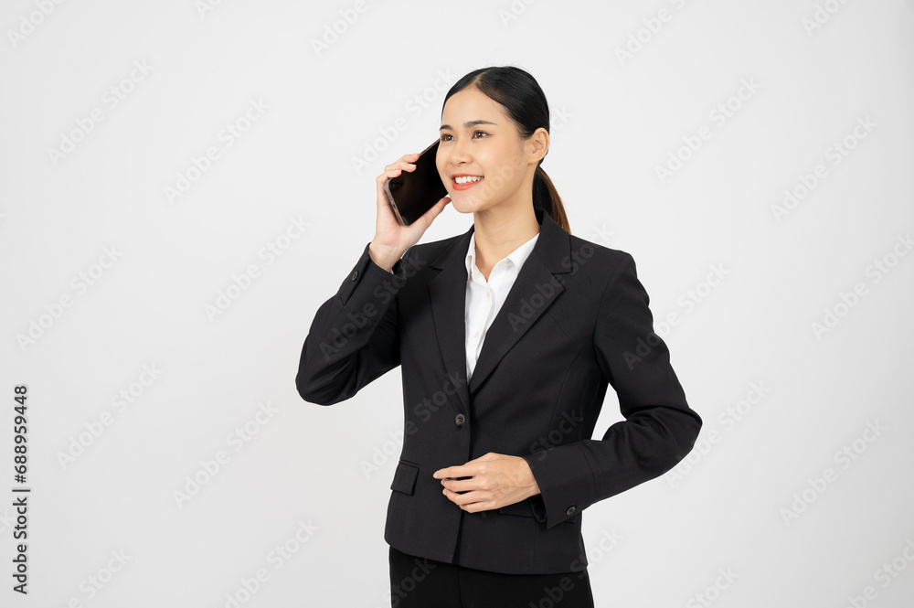 Confident Asian businesswoman using smartphone, having a phone call on white isolated background. Confident Asian businesswoman using smartphone, having a phone call on white isolated background.